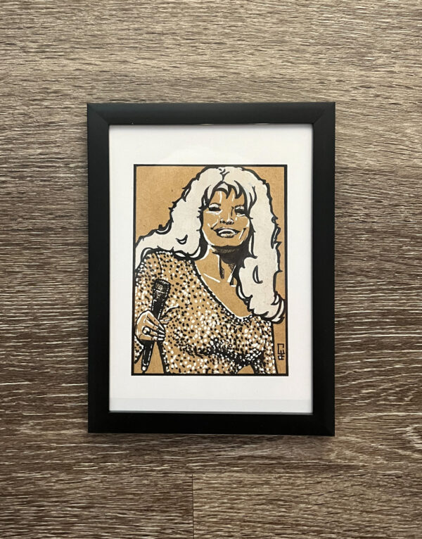 A portrait of Dolly parton is done in black and white ink plus white gosh. She is holding a microphone and wearing a glittery sequin dress.