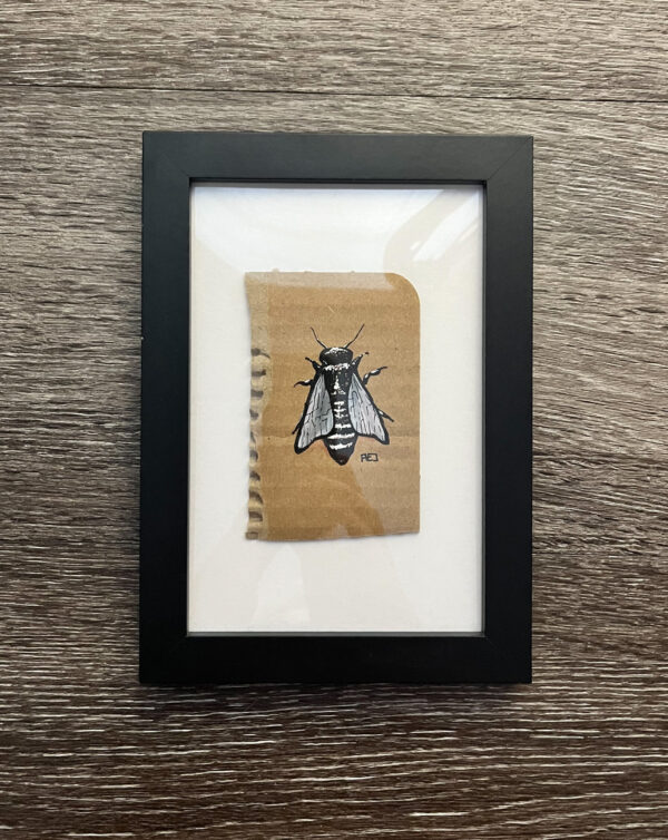 Black and white gouache ink illustration of a bee done on cardboard. Framed in black.